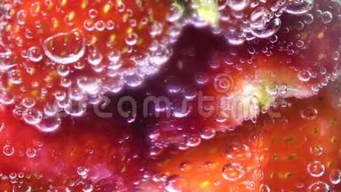 带有冰块和草莓的玻璃苏打<strong>水</strong>，<strong>中间</strong>屏幕。 泡沫膨胀。