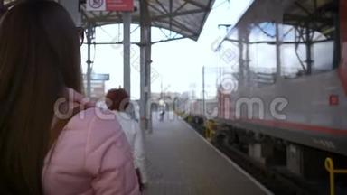 火车站的年轻漂亮的女人去火车。 带眼镜，长发，粉色夹克