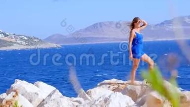 美丽的女人穿着蓝色的<strong>整体</strong>服装靠近大海