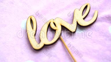 “爱”这个词是用<strong>细粉</strong>色背景上的木制字母构成的