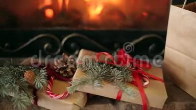 圣诞礼物装饰着云杉树枝，球果，丝带放在壁炉旁.. 温<strong>暖</strong>的原木着火了。 <strong>圣诞节</strong>