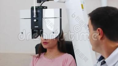 眼科治疗-一名年轻<strong>女子</strong>用一台<strong>特殊</strong>的大视光机器检查视力