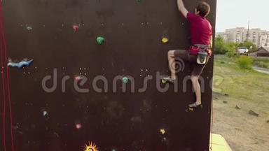 <strong>登山</strong>者的空中运行速度攀岩轨道上的人造墙<strong>户外</strong>。 年轻的快运动员在悬崖上爬