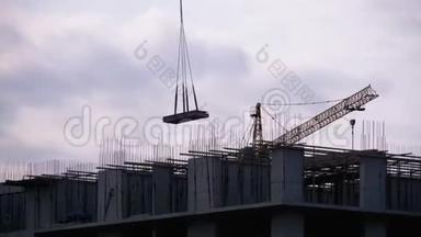 建筑工地上的塔式起重机在高层建筑上起重。