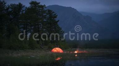夜晚露营和池塘附近火焰的时间