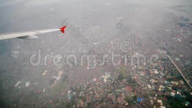 马尼拉市的全景，从一架飞行飞机的窗户。 在飞行中射击。 菲律宾。