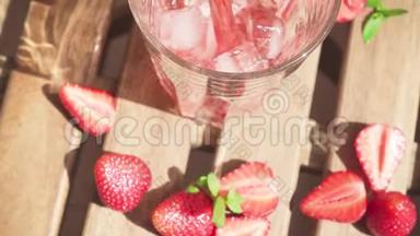 <strong>草莓汁</strong>慢慢地倒入桌子上的玻璃杯中