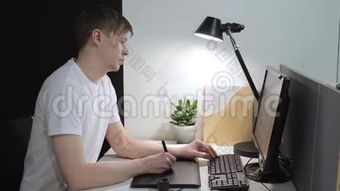 年轻人在办公室里用钢笔平板电脑完成项目设计。