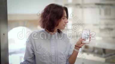一位卷发女士爬上电梯，一位女士通过手机上的玻璃拍摄照片或视频。