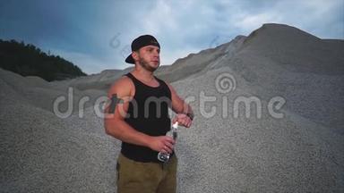 一个运动员在露天喝<strong>塑料</strong>瓶里的<strong>矿泉水</strong>
