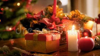 特写4k视频的红色礼盒，蜡烛和圣诞树.. 冬季庆典和假日的完美背景