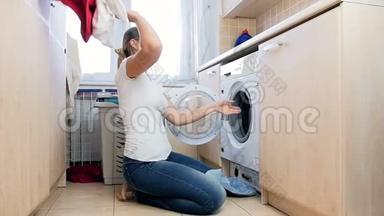 <strong>慢镜头视频</strong>快乐的笑女从洗衣机里拿出衣服扔空气