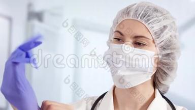 医院里的专业女医生戴上医用手套。 女医生