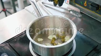 厨师手戴手套，将豌豆放入锅中，放入切碎的大蒜