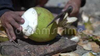 当男人用大砍刀切下一个年轻的椰子时，伊斯勒曼会慢慢地向我们展示如何获得美味的果汁