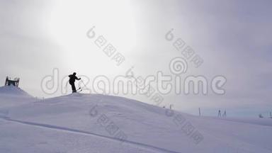 滑雪者在山地滑雪坡上跳跃的剪影。