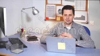 IT专家高兴地看着笔记本<strong>电脑显示</strong>器，他喜欢在办公室工作