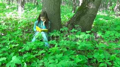 一幅可爱的十几岁女孩在森林里看书<strong>翻页</strong>的画