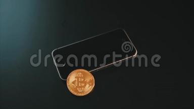 智能手机上的物理比特币`黑色背景的屏幕上
