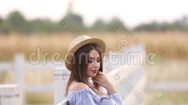 近距离观看美丽的孕妇穿着蓝色连衣裙散步听到农场。 微笑和快乐。 慢速视频