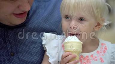那个金发<strong>女</strong>孩有趣可爱的小<strong>女</strong>孩在大购物中心吃冰淇淋和<strong>喇叭</strong>。 一家人吃冰淇淋