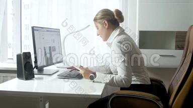 4k视频美丽的年轻女商人在办公室里用文件打字