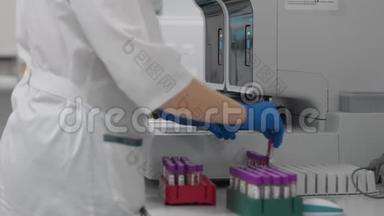 实验室技术人员在自动医疗设备中准备<strong>血液</strong>样本