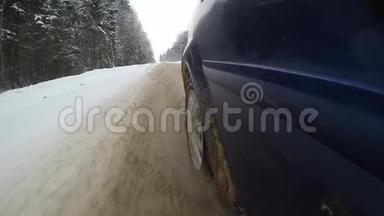 脏雪从汽车的车轮下飞了出来。 汽车`侧的慢动作视频视图。 开着一辆车