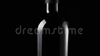 豪华红酒。 一瓶红酒，由桌子上美味的红葡萄在黑色背景下制成。 慢动作