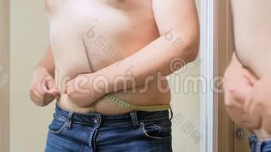 4k片年轻人用卷尺测量他的大肚子