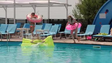 <strong>夏日派对</strong>，女孩们在泳池边用床垫和充气戒指休息，女朋友穿着泳衣跳跃