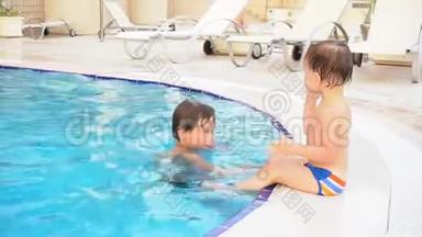 两个男孩弟弟在度假村的游泳池里洗澡