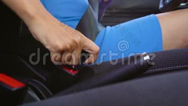 穿蓝色连衣裙的女士在开车前坐在车内系好<strong>安全带</strong>