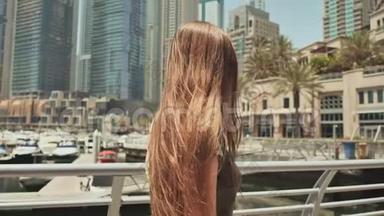 一个<strong>长发女孩</strong>走过迪拜市。