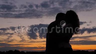 浪漫情侣<strong>剪影</strong>。 男人和女人在一起，<strong>情人</strong>在夕阳下亲吻