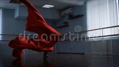 职业舞者在他面前完成了他美丽的红色布波舞。 他拿起一块大红布