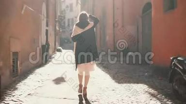 阳光明媚的一天，年轻的旅游妇女走上<strong>小街</strong>。 女孩在欧洲度假，探索古镇。