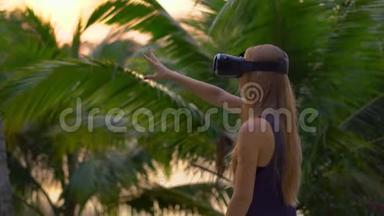 一位美丽的年轻女子的<strong>特写</strong>镜头在热带公园里使用VR<strong>耳机</strong>。 一个戴着虚拟现实眼镜的人感觉他