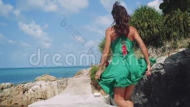 年轻<strong>漂亮</strong>的女人穿着<strong>绿</strong>色的裙子在海边奔跑，对<strong>大</strong>自然、假期、夏天、假期感到兴奋和惊讶。 慢慢慢慢