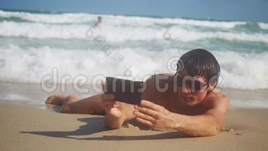 男游客手里拿着智能手机，在海滨海滩上自拍，暑假游客