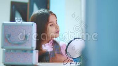 梳头的黑发小女孩照镜子。 小西班牙女孩在家里梳头