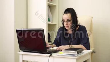这位戴眼镜的妇女在工作日看<strong>电脑显示器</strong>