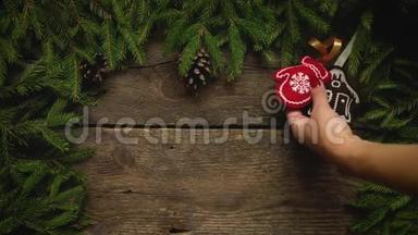 女人`手创造圣诞装饰。 圣诞树上的树枝，木纹上有圆锥和圣诞装饰