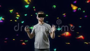 在蝴蝶云互动触摸虚拟蝴蝶黑中佩戴VR眼镜的男子