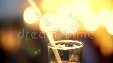 鸡尾酒会，一种在装有管子的玻璃中加入冰块的饮料，在肥皂、灯、闪烁的灯光下。 <strong>原件</strong>