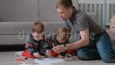 家里的爸爸和两个<strong>双胞胎兄弟</strong>一起画记号笔，把毛笔放在地板上。