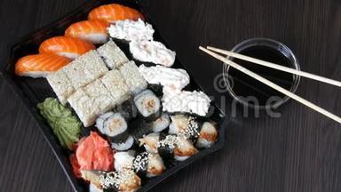 大型寿司套装，有很多寿司，卷，肉卷，黑吉里，甘坎。 时尚寿司套在黑木桌旁边的大豆