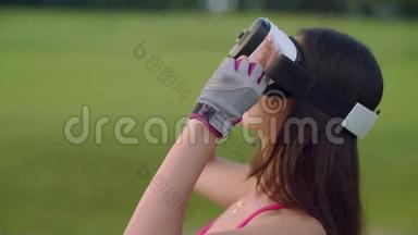 亚洲女人在公园里使用VR耳机。 户外女士头上的VR眼镜