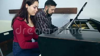 男教师，女学生在音乐<strong>学校</strong>弹<strong>钢琴</strong>