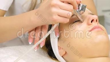 美容师正在为年轻女孩<strong>做手术</strong>。 微磨擦的工艺。